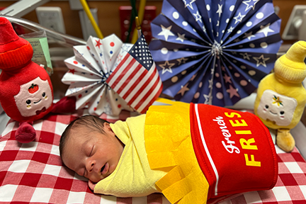 NICU baby dressed as french fries for July 4th