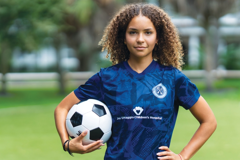 Fight the Unfair with Florida's top-ranked children's orthopedics. Gianna holding soccer ball.