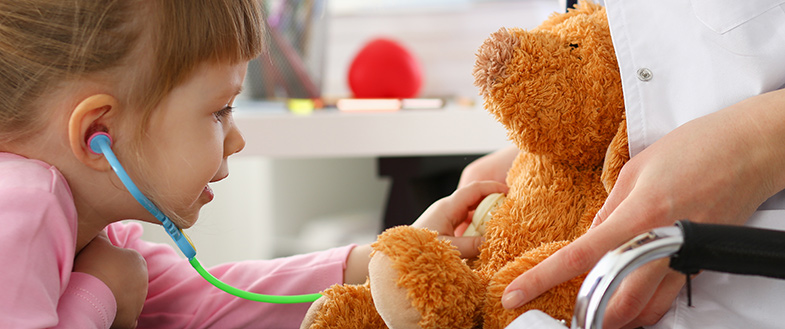 girl listens to teddy bear heart with stethoscope 